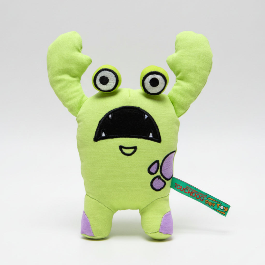 Green cartoon monster plush dog toy with big eyes and open tag