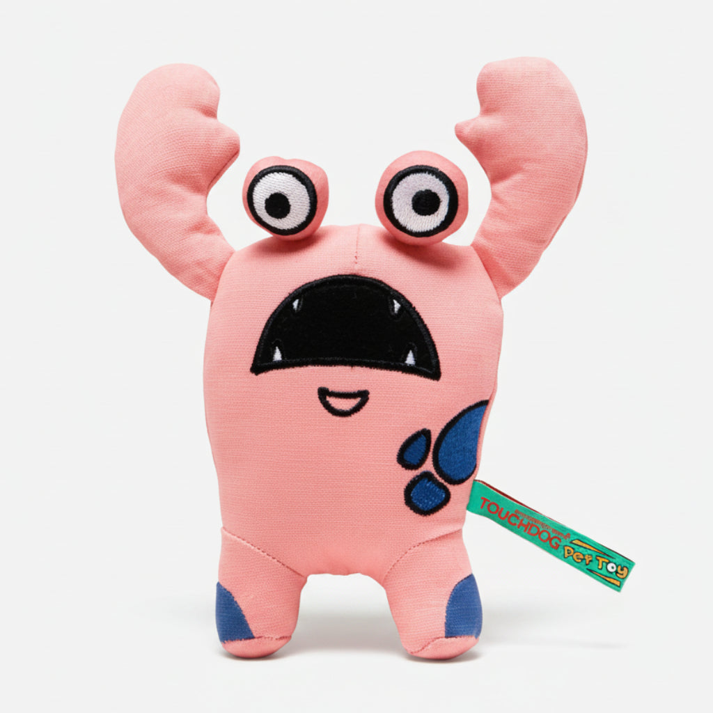 Pink cartoon monster plush dog toy with big eyes and open tag