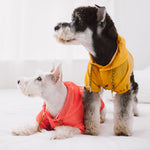 Yellow waterproof dog raincoat with hood, snap front, split-vent, stitched pockets.