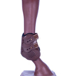 Brown fetlock boot with two straps and perforated front panel on hoof