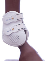 White fetlock boot side with perforated toe pad and metal studs
