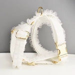 White lace dog harness with ruffled straps and gold buckles