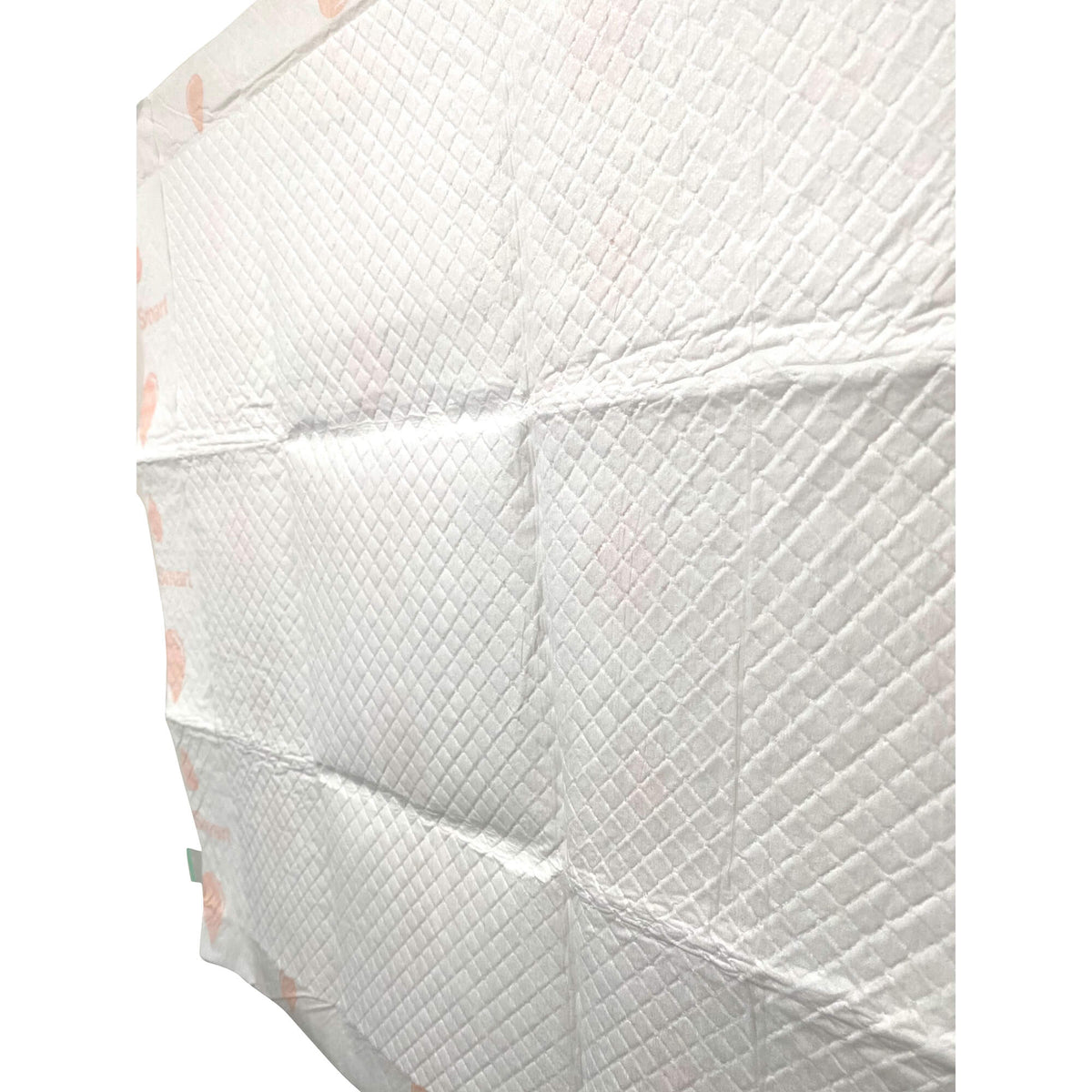 Folded stack of off-white puppy training pads with quilted texture and pink heart accents
