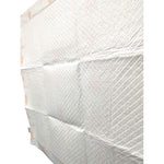Folded stack of off-white puppy training pads with quilted texture and pink heart accents