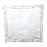 Single folded white dog training pad with light paw-print pattern on outer layer.