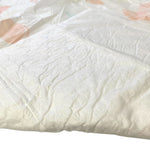 Close-up of a white heavyweight dog training pad with embossed texture.