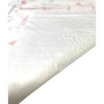 WizSmart heavyweight dog training pad, white absorbent surface in close-up.
